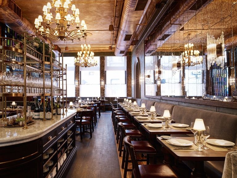 The AURUM dining room, vaulted ceilings and brass chandeliers